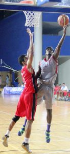 Aravind Annadurai of IOB Chennai lays the ball up with his left hand against Ramesh Sihag of Army Red